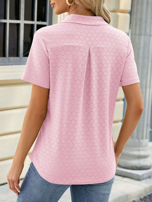 Blush pink eyelet polo collar blouse with short sleeves and a back pleat detail.