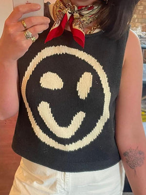 Black knit tank top with large cream smiley face graphic.