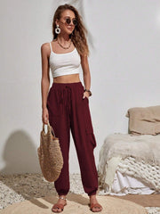 Burgundy textured cargo lounge trousers with drawstring waist and side pockets.