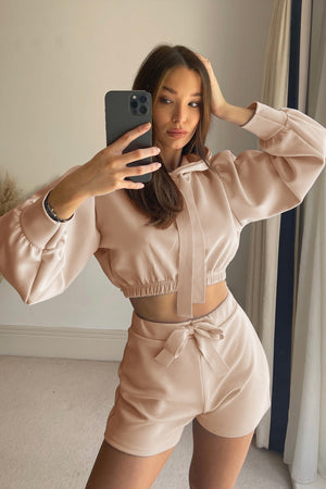 Blush pink cropped hoodie and shorts set with tie details and balloon sleeves.