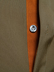 Olive green button-down shirt with contrast trim and button detail