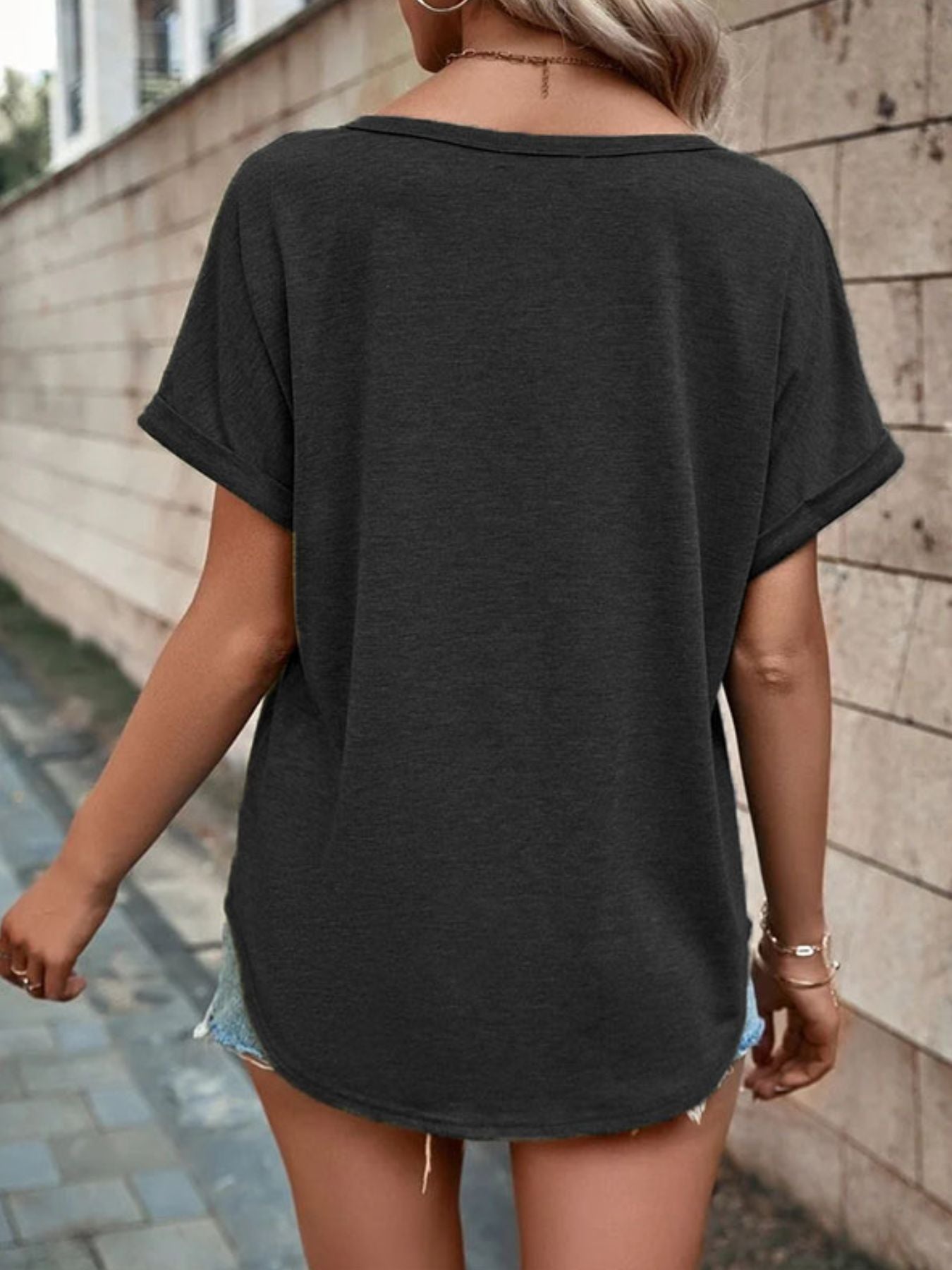 Buttoned V-neck short sleeve t-shirt in dark gray with cuffed sleeves.