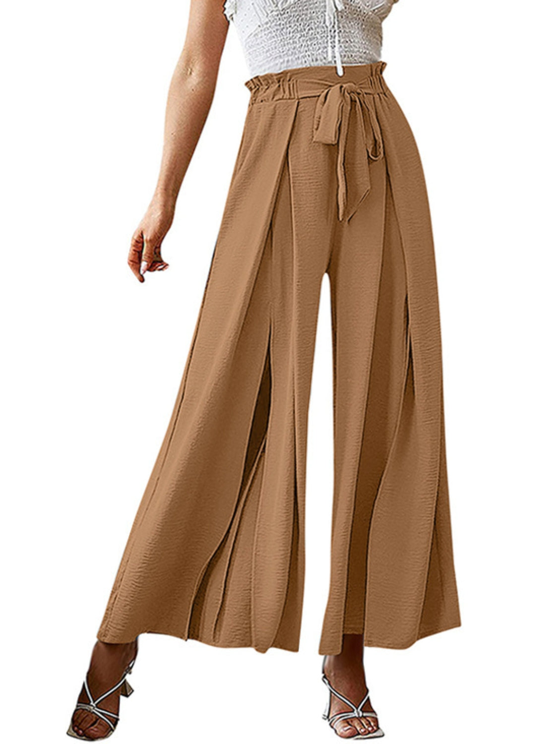 Caramel paperbag waist palazzo pants with side slits and a tie belt.