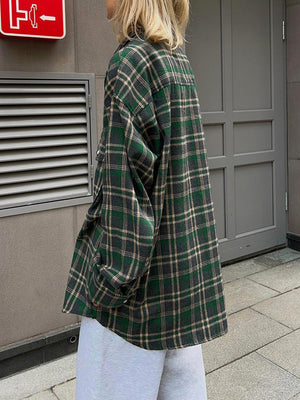Plaid pocketed button-up shacket in dark green with button details.