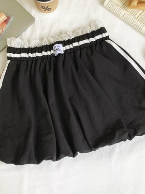 Black mini skirt with lace trim, gathered waist, and white side stripes.