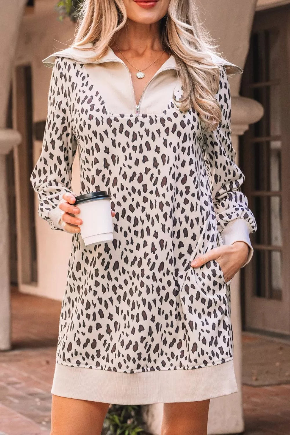 Leopard print zip-up collar mini dress with pockets and long sleeves.