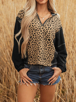 Leopard print zip hoodie with black sleeves and knotted cuff detail.