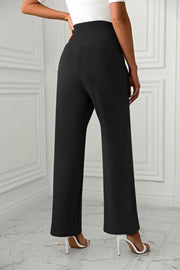 Black wide-leg trousers with a sculpted high waist, shown from the back.