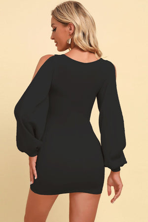 Black bodycon dress with sculpted balloon sleeves and cut-out shoulders.