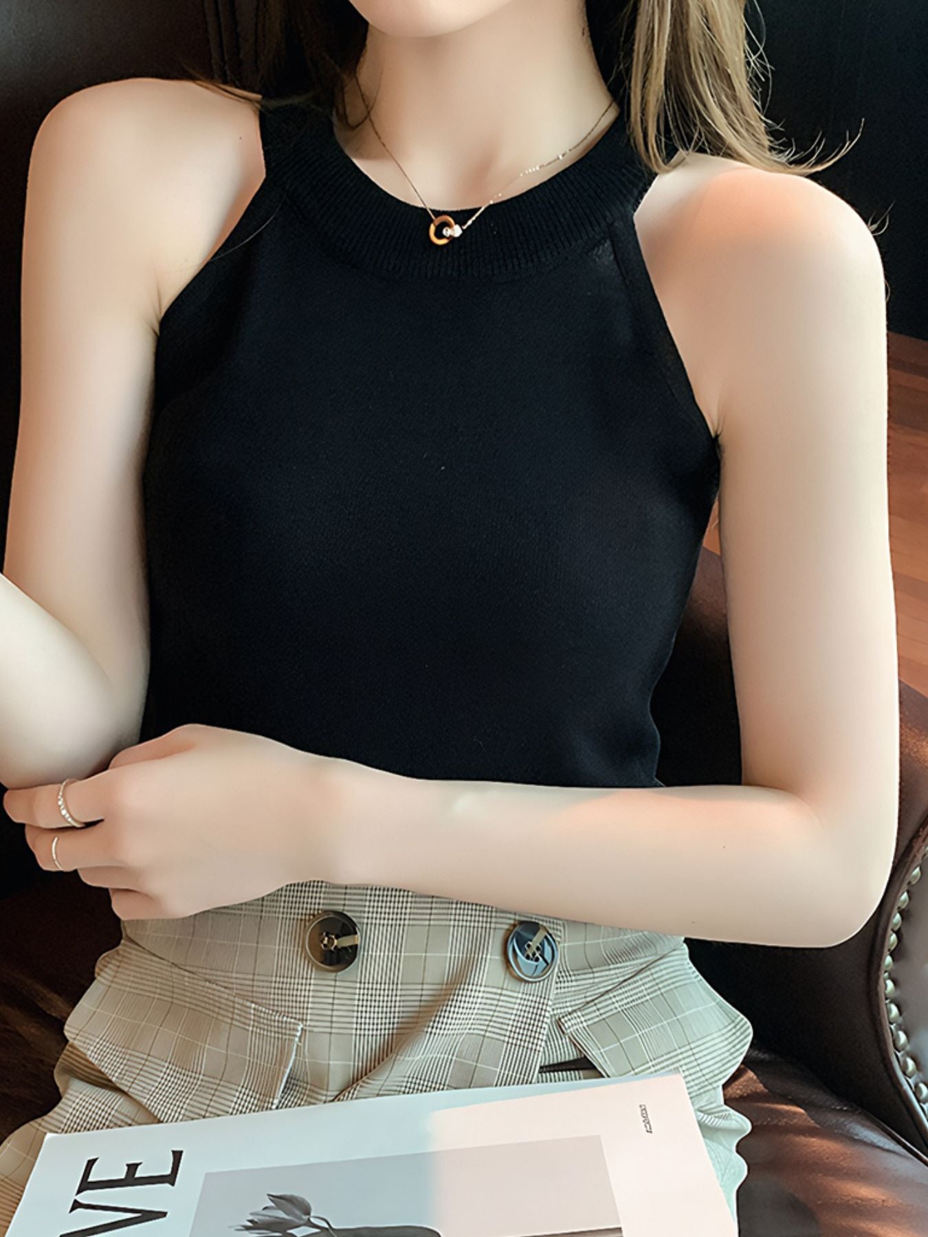 Black ribbed knit cami tank top with mock neck and sleeveless design.