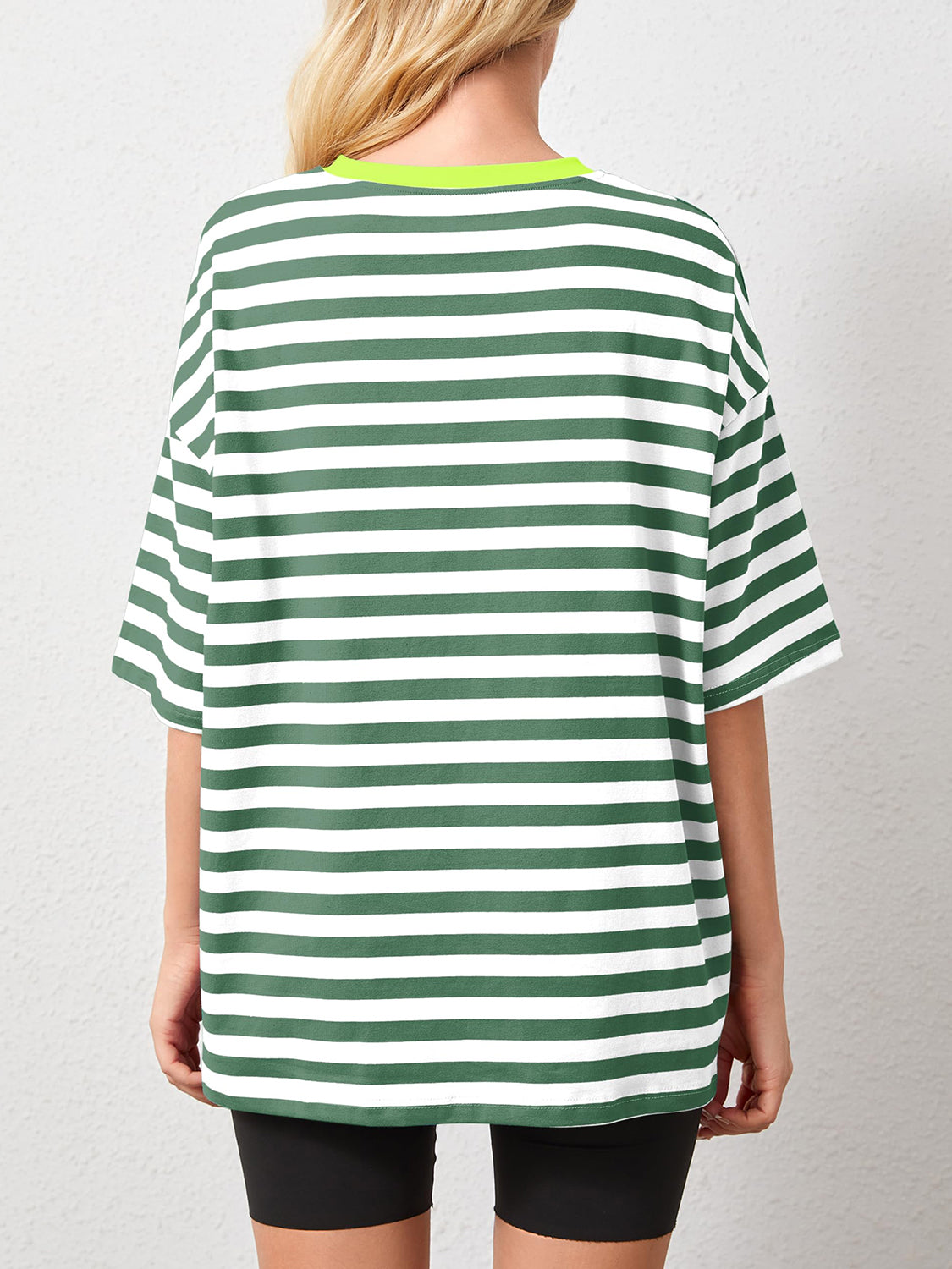 Oversized striped tee in dark green and white with dropped sleeves and a neon green neckline.