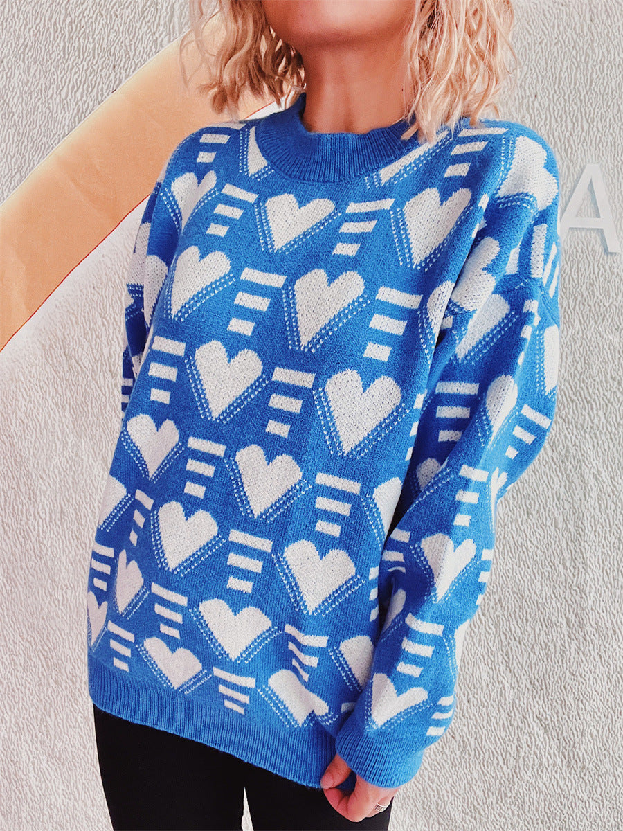 Blue acrylic knit jumper with allover white geometric heart pattern, crew neck, long sleeves.