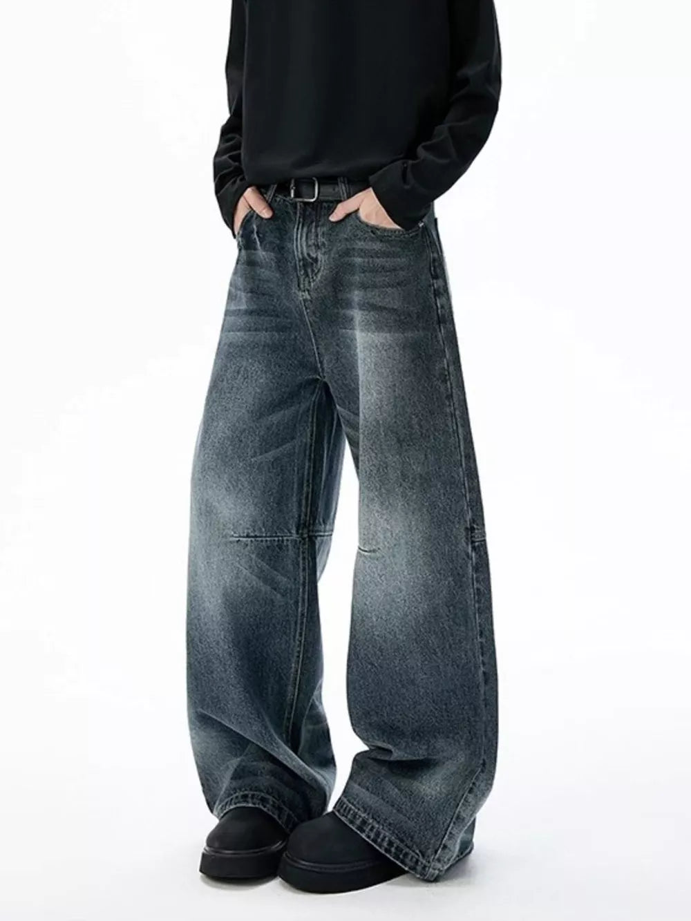 Belted dark-wash wide-leg jeans with unique paneled design and a relaxed fit.