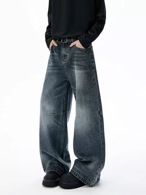 Belted dark-wash wide-leg jeans with unique paneled design and a relaxed fit.