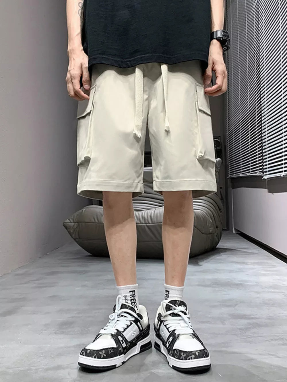 Relaxed fit apricot cargo shorts with drawstring and side pockets.