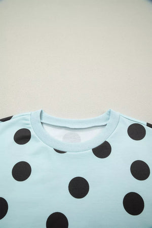 Light blue crew neck top with black polka dots