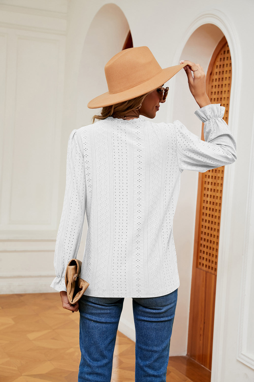 White perforated blouse with ruffle cuffs and long sleeves