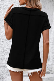 Black vertical ribbed tee with short sleeves and split hem detail.