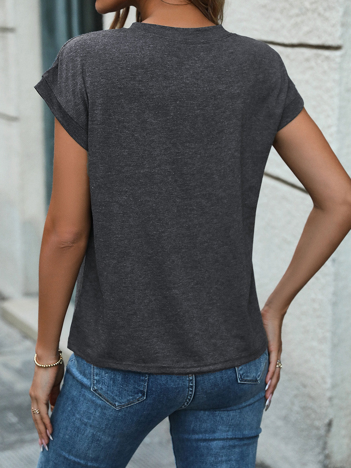Dark gray slouchy henley tee with cuffed sleeves and a relaxed fit.