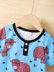 Baby pajama set with highland cow print on light blue, black trim, henley neckline, short sleeves.