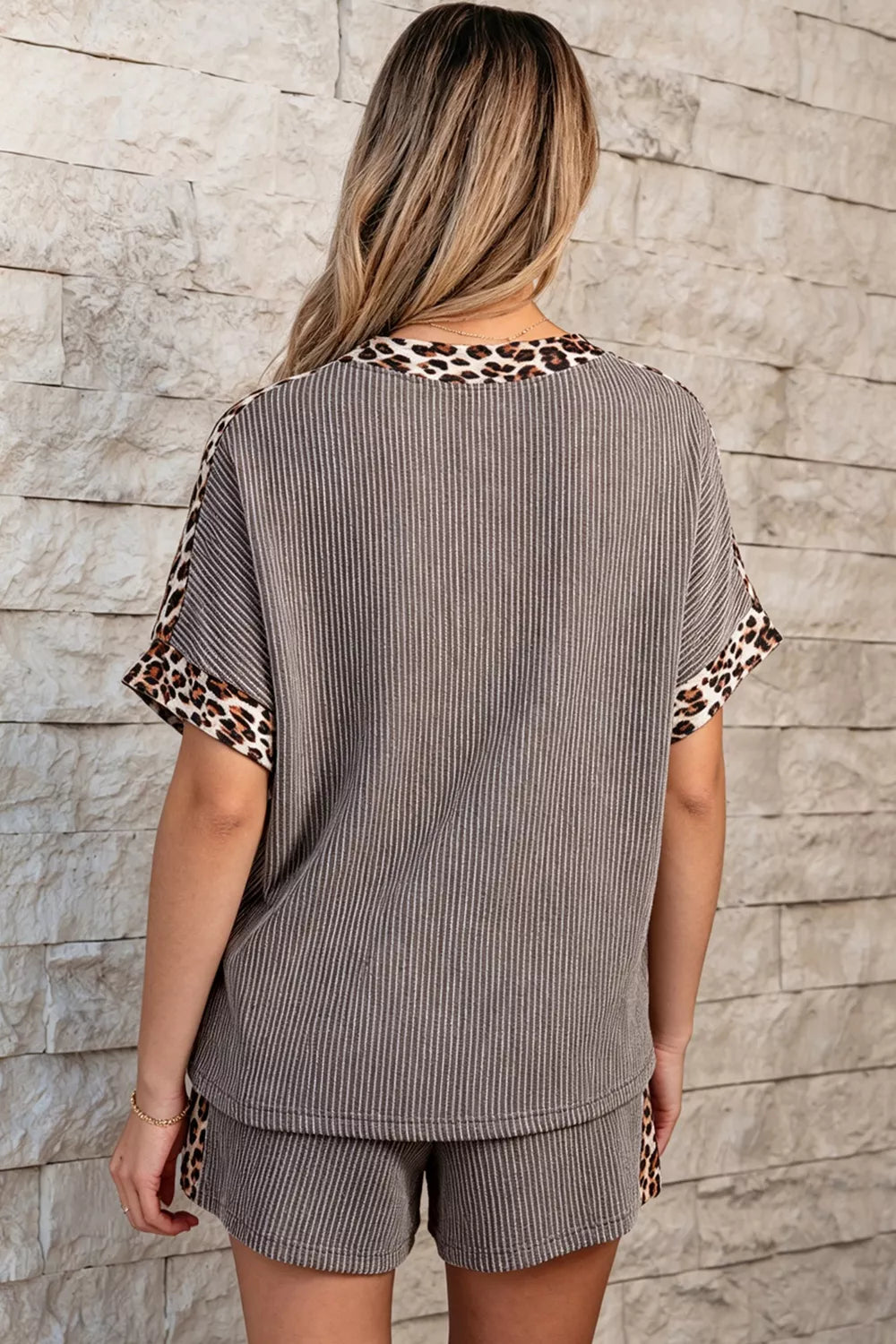 Ribbed knit two-piece set with vertical stripes and leopard trim on neckline and sleeves.