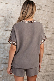 Ribbed knit two-piece set with vertical stripes and leopard trim on neckline and sleeves.
