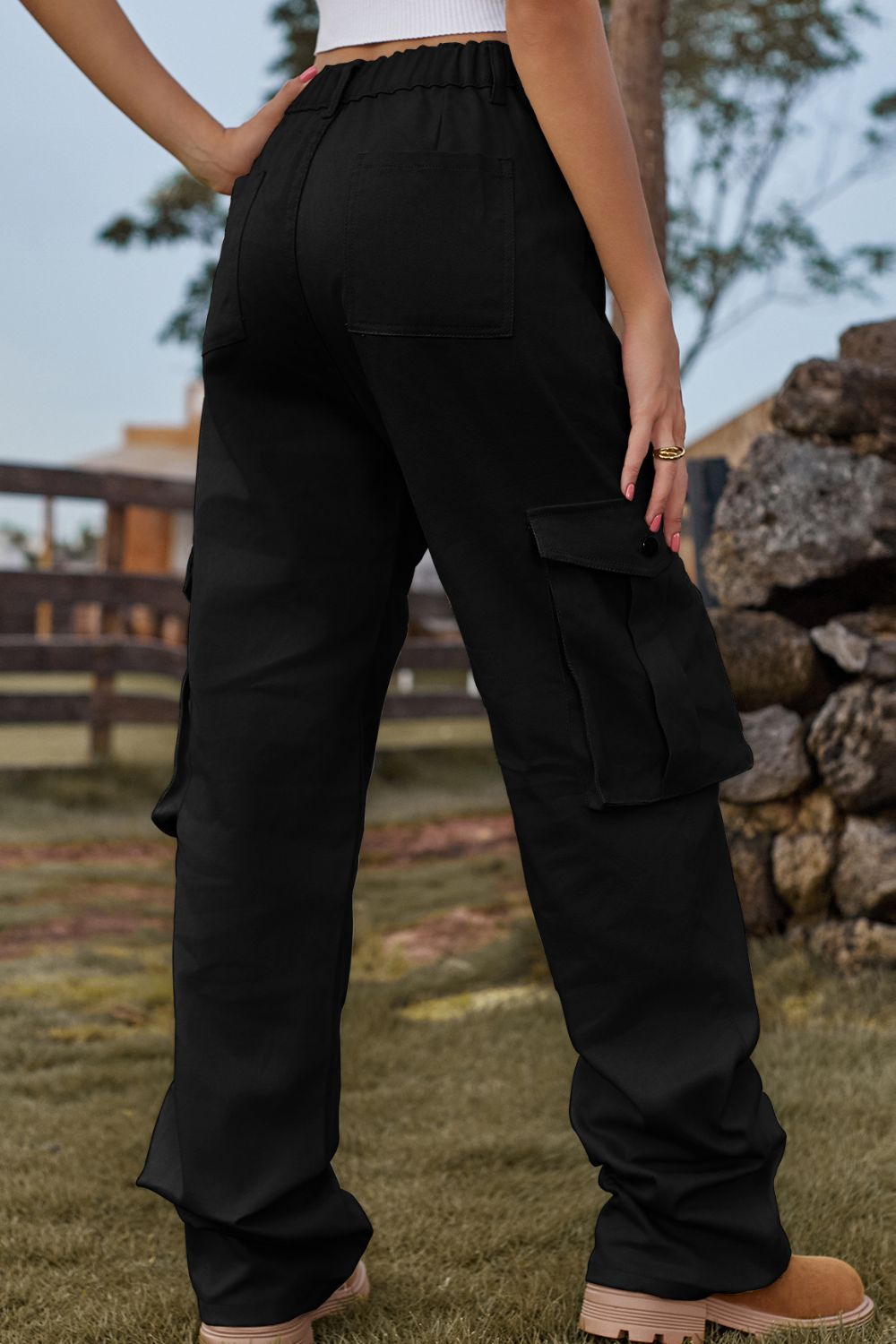 Black utility cargo pants with wide legs and multiple pockets.