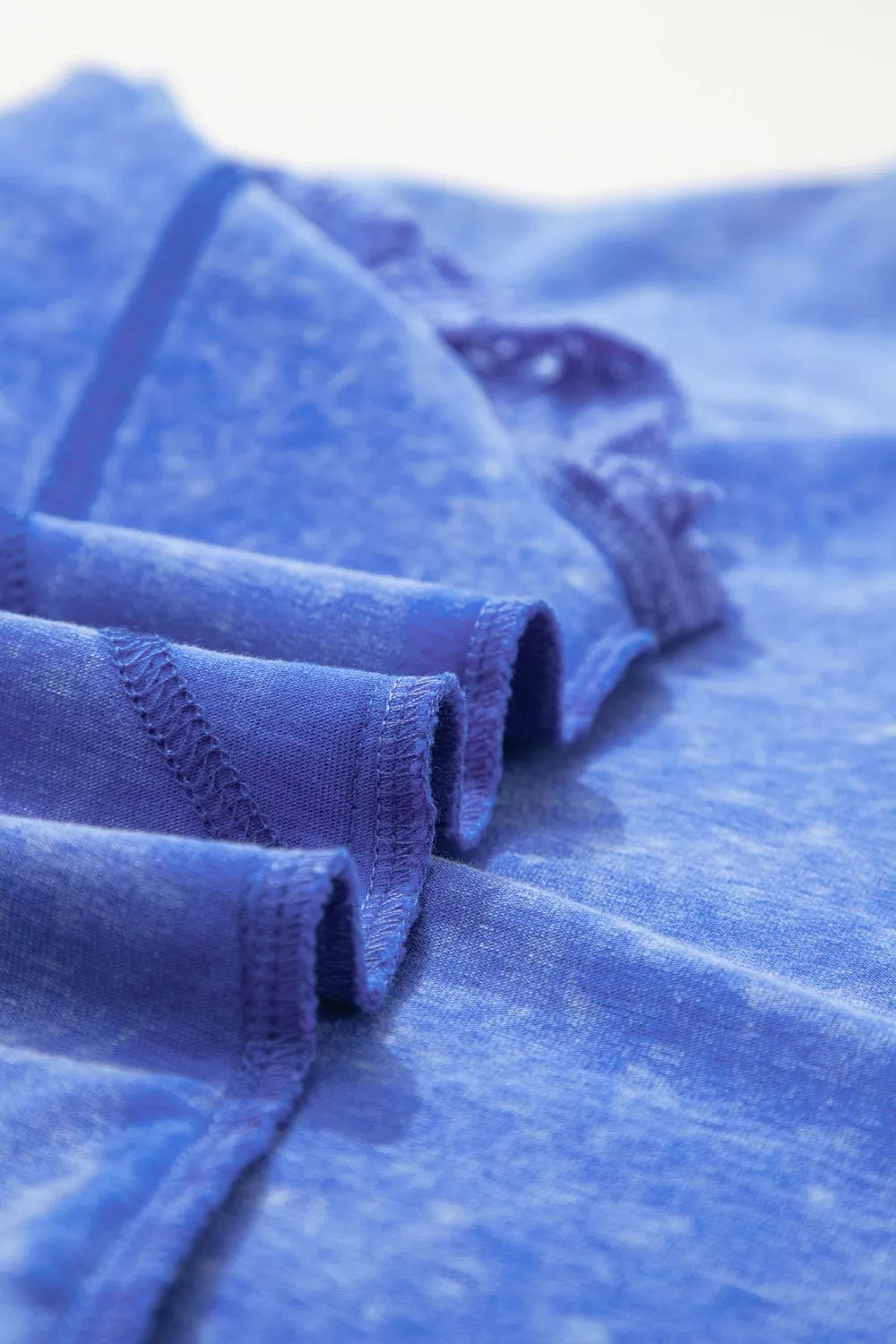 Blue mineral wash cotton tee with lace trim and distressed details