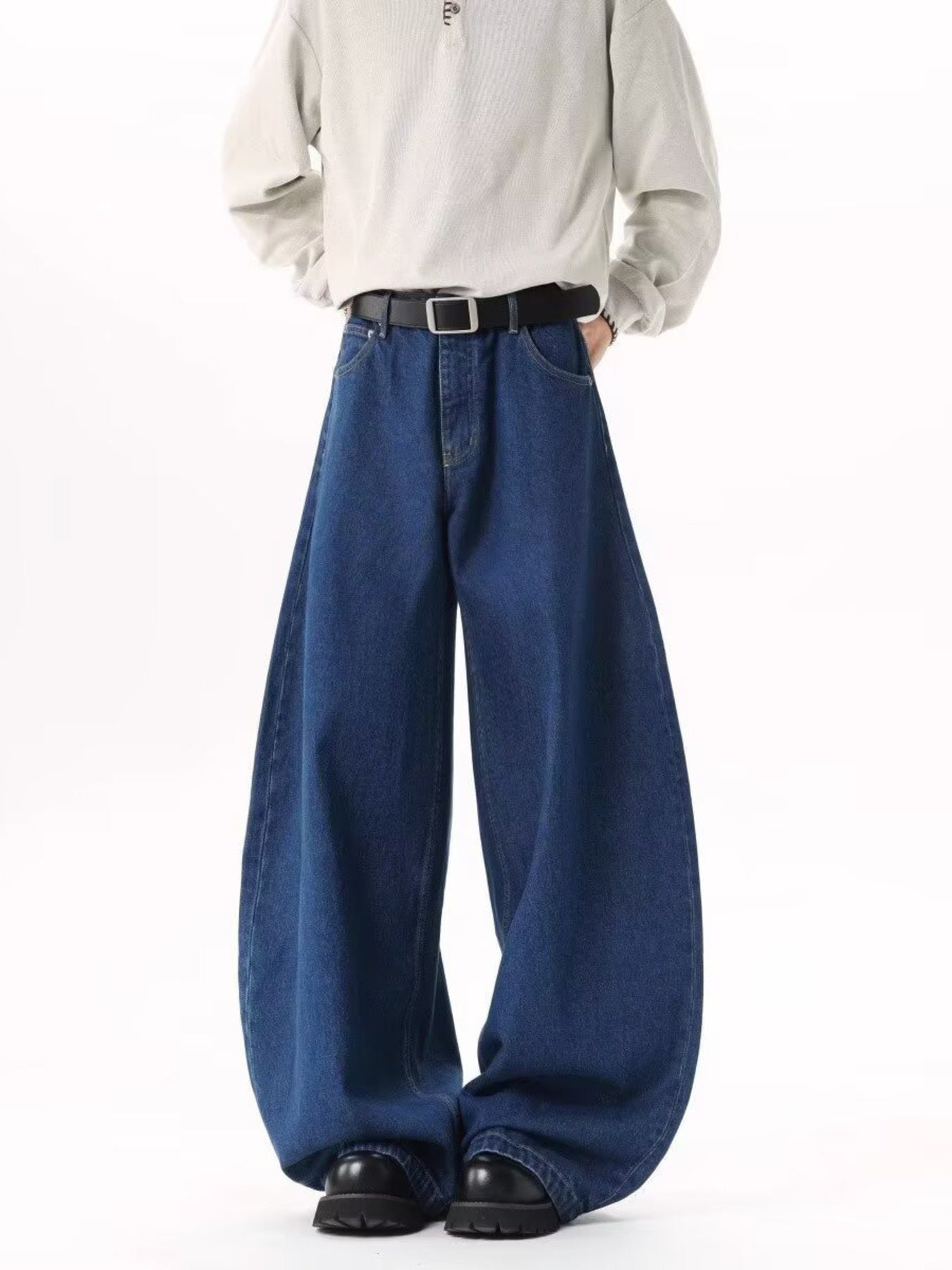 Men's dark blue wide leg jeans with contrast stitching and belt loops.