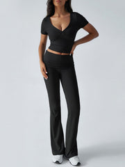 Black ruched waistband flared lounge pants and a short sleeve V-neck wrap top.