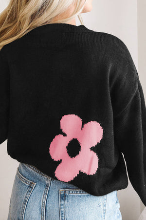 Black acrylic crewneck sweater with a pink floral intarsia knit detail.