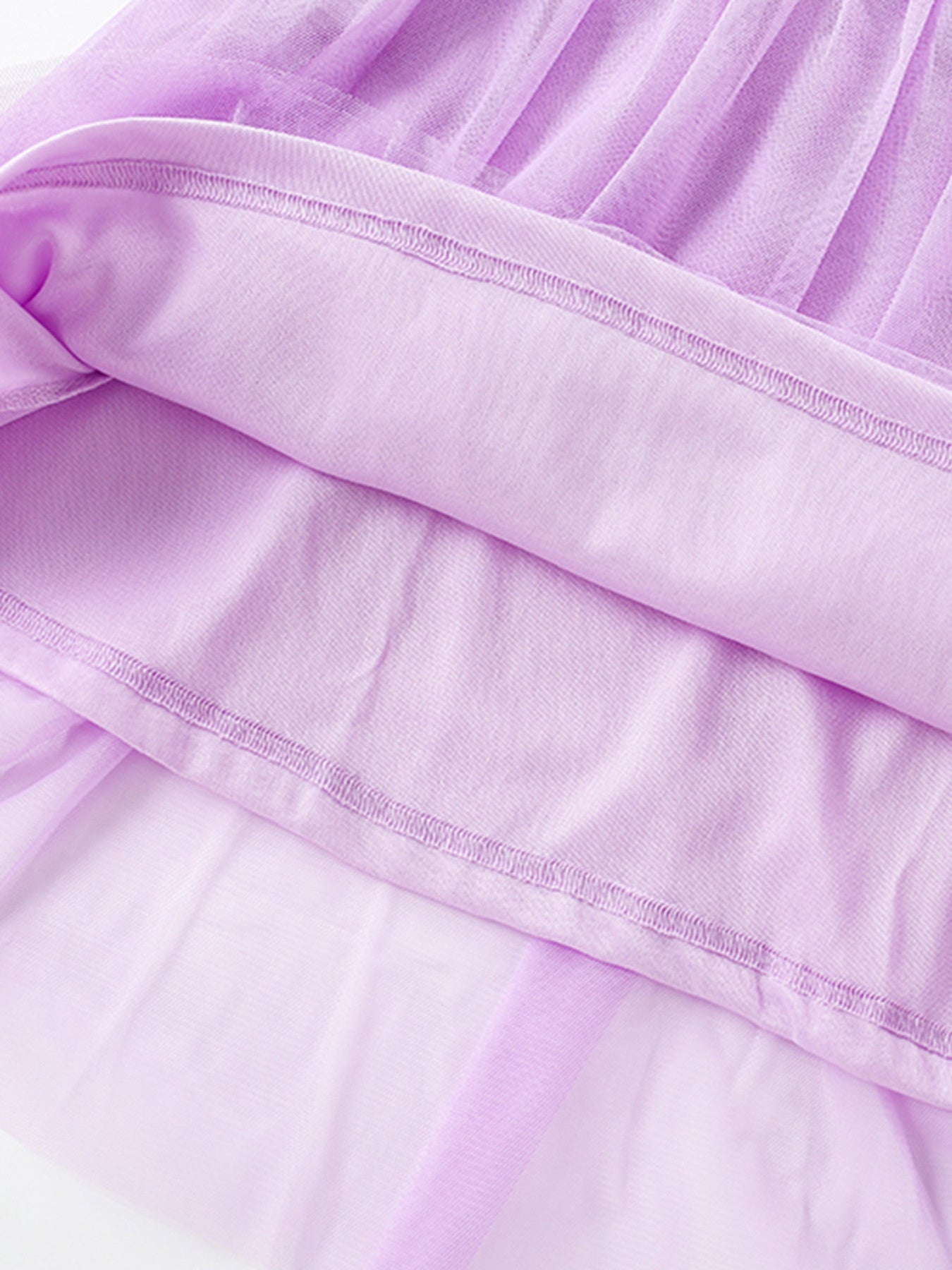 Lavender tulle toddler dress with cotton lining and detailed stitching.