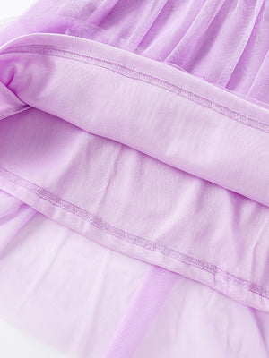 Lavender tulle toddler dress with cotton lining and detailed stitching.