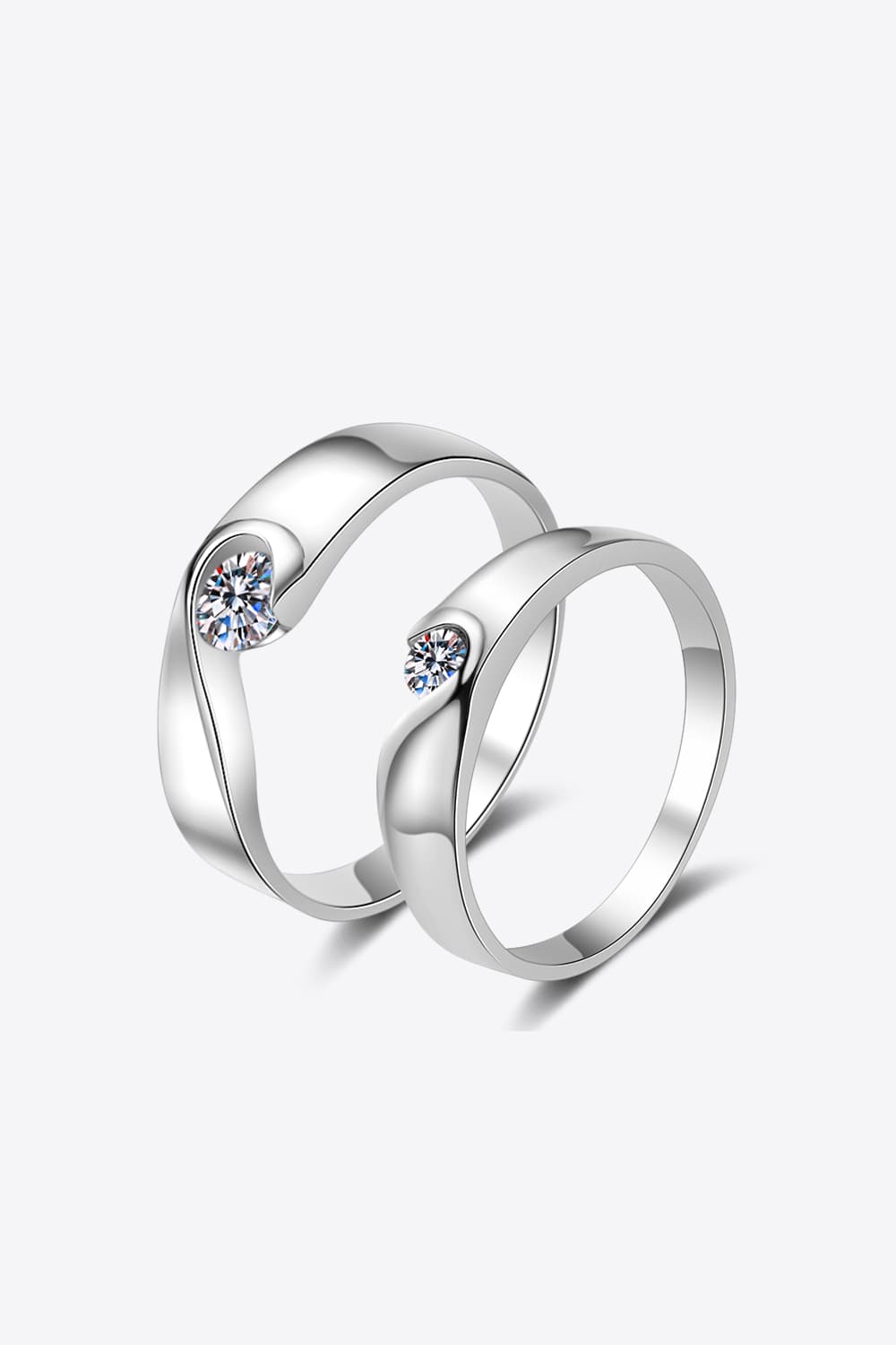 Curved Embrace diamond ring set in silver with a single stone on each ring.