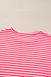 Pink and white striped textured top with crew neck and balloon sleeves.