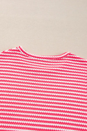 Pink and white striped textured top with crew neck and balloon sleeves.