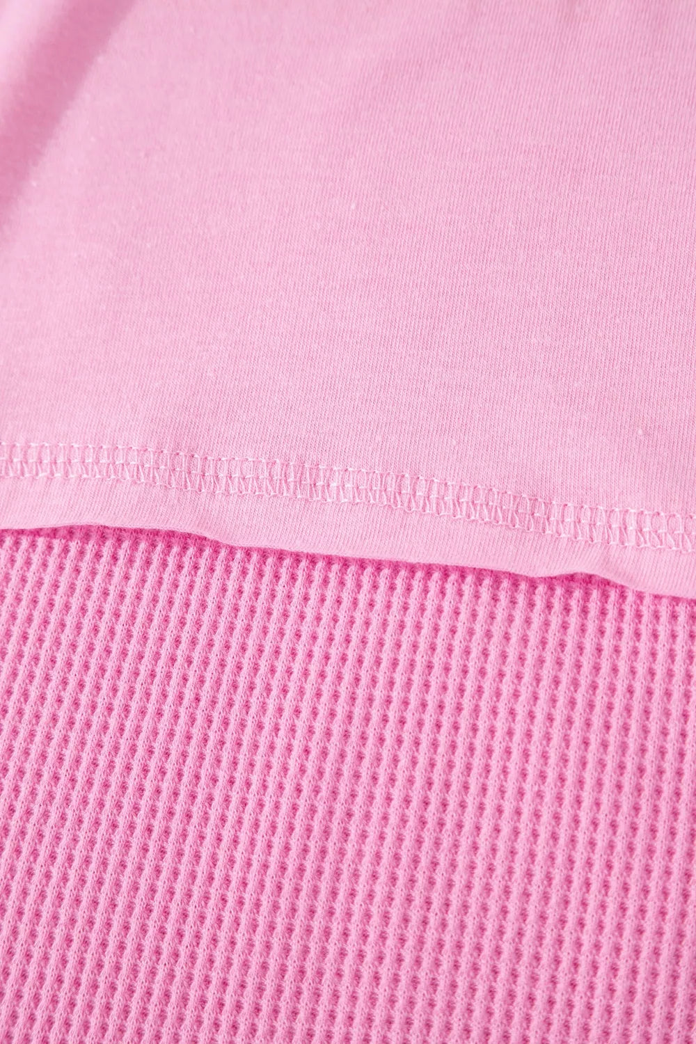 Pink waffled seam pocketed t-shirt detail showing textured waffle knit fabric.