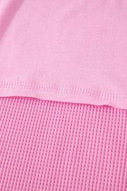 Pink waffled seam pocketed t-shirt detail showing textured waffle knit fabric.