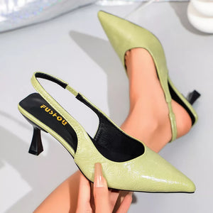 Elegant green kitten heel slingback pumps with a pointed toe and embossed pattern.