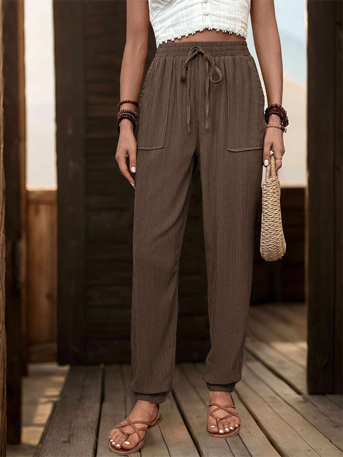Textured drawstring waist relaxed trousers in coffee brown with cuffed ankles and pockets.