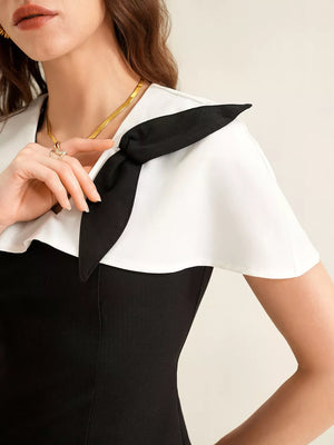 Black and white peplum set with a bow detail on the collar.