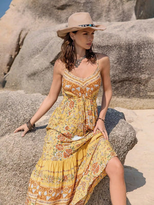 Yellow floral tiered cami maxi dress with tassel detail and V-neck.