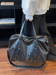Distressed black vintage leather travel organizer bag with top handles and shoulder strap.