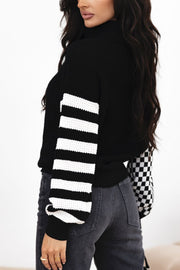 Black knit turtleneck sweater with checkerboard and stripe sleeves