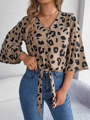 Khaki leopard print tie-front blouse with button detail and bell sleeves.