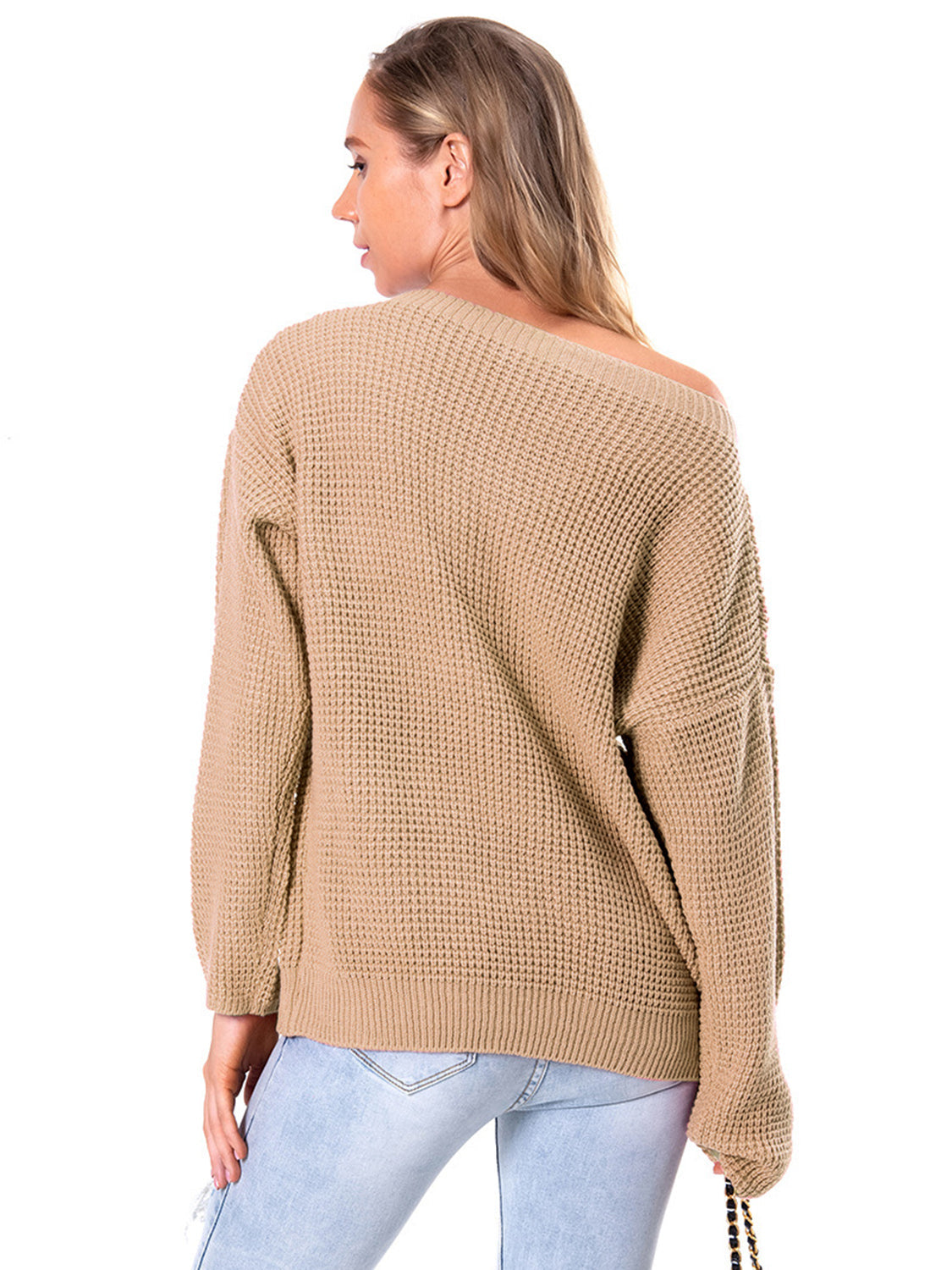 Off-shoulder waffle knit sweater in tan with long sleeves and a slouchy fit.