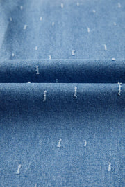 Blue denim jeans with distressed details and a raw hem.