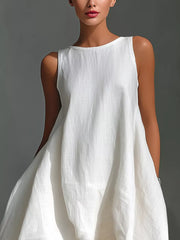 White asymmetrical sleeveless flowing dress with a relaxed fit and round neckline.