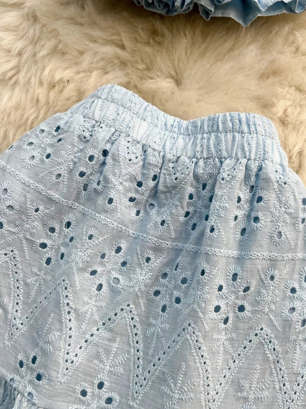 Light blue eyelet maxi skirt with elastic waistband and ruffled crop top detail.