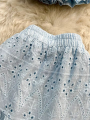 Light blue eyelet maxi skirt with elastic waistband and ruffled crop top detail.